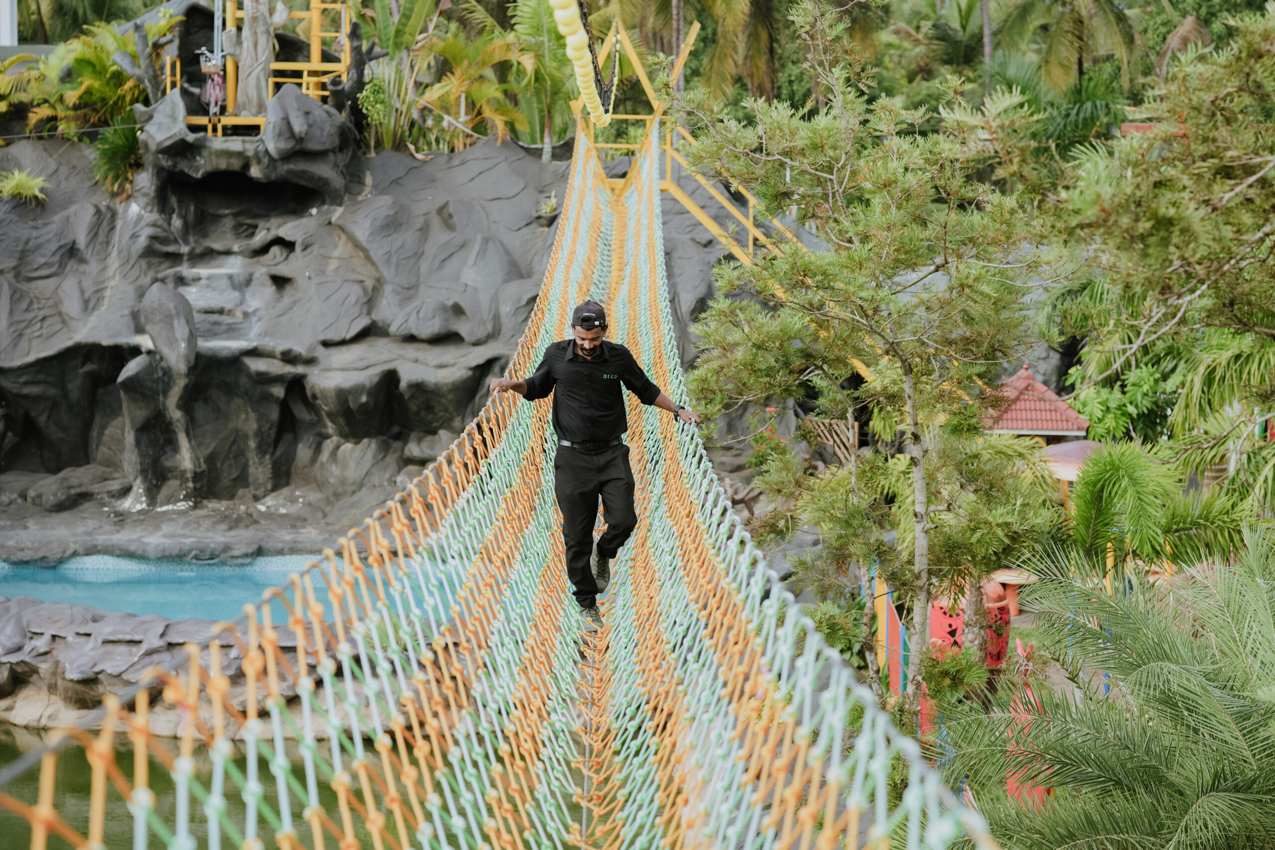 Visitor crossing a rope bridge at Arco Park ’N’ Resort, Kasaragod
